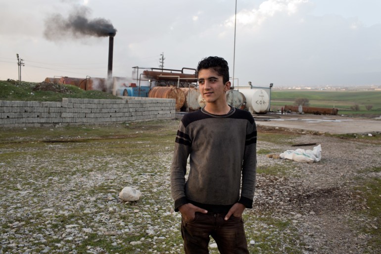 TANJERO, IRAQ: Jamal (17) stands in front of the refinery. The family of Yezidis, displaced from Sinjar, live next to an oil refinery in the Kurdish Region of Iraq. The young men run the refinery 24 hours a day with little to no safety equipment. (Photo by Sebastian Meyer/Corbis via Getty Images)